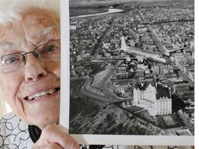 Mary Schlader holds an old U.S. Air Force aerial photo of the Hotel Macdonald Edmonton. The 92-year-old senior delivered an original 1945 dinner menu to the hotel during their hotel amnesty event.