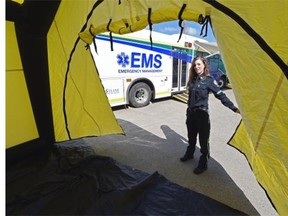 Melissa Edwards, EMS public education officer, with the new inflatable tent and new disaster response bus and trailers being added to the Emergency Medical Services (EMS) fleet on Friday, May 8, 2015.