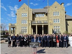 Newly-elected NDP MLAs line up in front of Government House in Edmonton to hear Premier-designate Rachel Notley’s speech before their first caucus meeting on May 9, 2015.