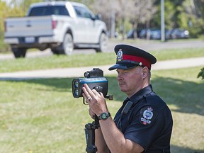 Const. David Debler watches traffic near University Avenue. Edmonton Police Service is taking part in Canada Road Safety Week from May 12-18.