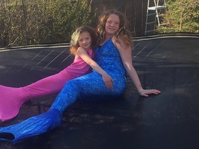 Sisters Isabelle and Genelle Rowe, age seven and 12, in the mermaid tails they are no longer allowed to wear in Edmonton pools.