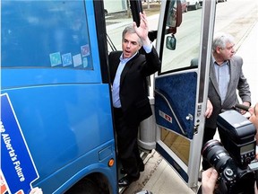 Alberta Premier Jim Prentice boards his campaign bus in Edmonton on April 7, 2015 after calling a provincial election on May 5, 2015.