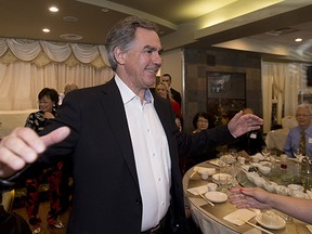 PC leader Jim Prentice prepares for a hug during a rally for Edmonton-Meadowlark candidate Katherine O'Neill at the Cha for Tea Palace Restaurant on May 3, 2015,  in Edmonton.
