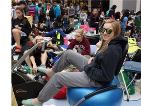 Kassidy Roznicki wears sunglasses while cycling for almost 24 hours at Francis Xavier High School on Friday April 24, 2015.