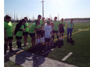 Jolene Cote’s children flip a coin to start a soccer tournament in their mother’s honour.