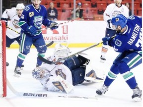 Oklahoma City Barons goaltender Richard Bachman couldn’t stop this shot by Utica Comets forward Wacey Hamilton during Game 5 of their American Hockey League playoff series on May 14, 2015, but he was almost perfect in Monday’s game in Utica, N.Y.