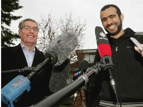 Omar Khadr (right) arrives at the home of his lawyer Dennis Edney (left) after being released on bail in Edmonton on May 7, 2015.