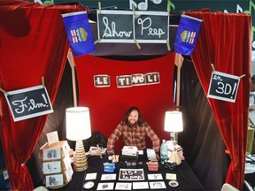 Patrick Ares-Pilon mans his Le Tivoli Show-Peep booth at Edmonton’s Royal Bison Art and Craft Fair in Old Strathcona on Sunday, May 10, 2015.