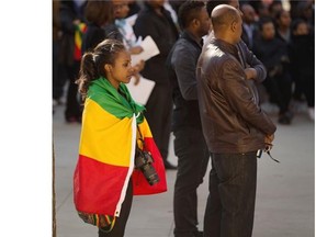 People assemble at Edmonton’s Churchill Square on April 26, 2015, for a prayer vigil in memory of the 28 Ethiopian Christians in Libya that were executed by ISIS this past week. The event was organized by the Ethiopian-Canadian Community Association in memory of their countrymen.