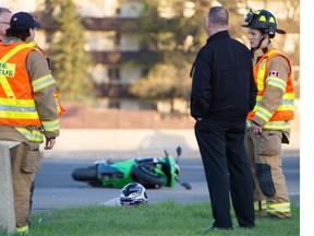 Police and firefighters attend the scene of a fatal collision at 122nd Street and Whitemud Drive on May 11, 2015.