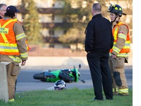 Police and firefighters at the scene of a motorcycle fatal collision at 122nd Street and Whitemud Drive in Edmonton on May 11, 2015