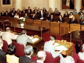 Premier Peter Lougheed rises to speak in the legislature in this undated file photo. At bottom right, with his desk separated from the Social Credit opposition, is the lone NDP MLA, Grant Notley.