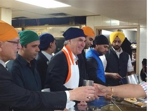 Progressive Conservative Leader Jim Prentice serves lunch at a Sikh gurdwara in Mill Woods on Sunday.