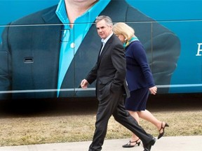 Progressive Conservative Leader Jim Prentice, walks next to his bus with his wife Karen before giving a speech on healthcare at Whitemud Creek Community Centre in Edmonton, April 14, 2015.