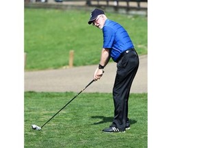 Psychologist Graeme Clark hits some balls at the Victoria Golf Course on May 15, 2015.