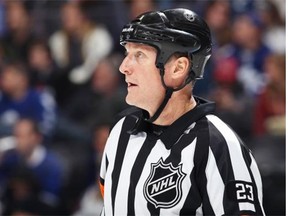 Referee Brad Watson oversees the action as he officiates his 1,000th NHL game as the Toronto Maple Leafs face the Colorado Avalanche at the Pepsi Center in Denver on Jan. 21, 2014,