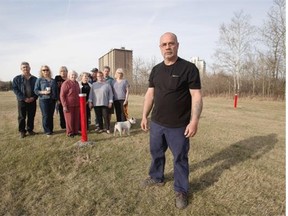 Jim Richardson, right, and other concerned Terrace Heights neighbours stand in a green space across the street from their homes where they believe the new Capilano library will be built. They worry it will bring traffic to a quiet area where residents like to watch wildlife and walk dogs.