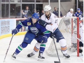 Rookie defenceman Darnell Nurse keeps a Utica Comets player away from the front of the net during Wednesday’s American Hockey League playoff game at the Cox Convention Center in Oklahoma City.