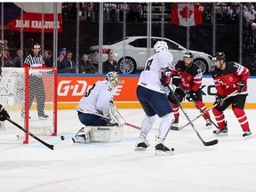 Jordan Eberle (right) tips the puck home to break a 3-3 tie midway in the third period.