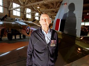 Second World War pilot Cliff Rhind stands beside a Mosquito aircraft at the Alberta Aviation Museum in Edmonton.