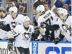 Sidney Crosby of the Pittsburgh Penguins celebrates with teammates after scoring a goal during an NHL playoff game against the New York Rangers on April 18, 2015, at New York’s Madison Square Garden.