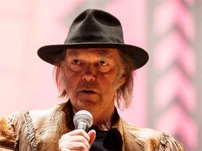 Singer Neil Young speaks during a press conference for the Honour the Treaties tour in Toronto, Sunday January 12, 2014.