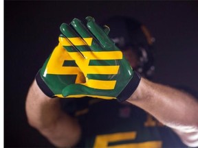 Quarterback Mike Reilly models gloves that are a part of the Edmonton Eskimos' new 'signature' uniform in a photo released by the Canadian Football League club on Tuesday, Sept. 2, 2014. The Eskimos will wear the uniform for the first time when they play the Calgary Stampeders at Edmonton's Commonwealth Stadium on Saturday, Sept. 6.