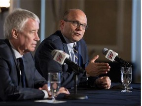 Edmonton Oilers CEO Bob Nicholson, left, and new President and General Manager Peter Chiarelli speak during a press conference in Edmonton, Alta., on Friday April 24, 2015.