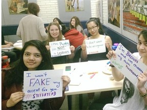 Students at Harry Ainlay High School show their handiwork after the launch of the #stophateab social media campaign by the Alberta Hate Crime Committee.