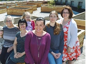 Sunshine Garden co-ordinator Sherry Prokopuk, centre, with volunteers to the right, Kristen Ahlskog and Carrie Carbol-Ritcey and left, Jocelyn Crocker and Bonnie Carbol with granddaughters Nora, 3 and Lily, 8, at the Fulton Place Community Garden on Sunday.