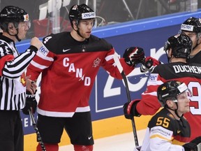 Taylor Hall celebrates his second goal with linemates Matt Duchene and Jordan Eberle. Is Mr. Referee asking for a fist-bump of his own?