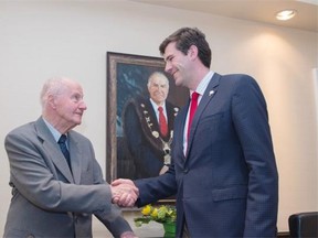 Terry Cavanagh is congratulated Wednesday by Mayor Don Iveson at the Fairmont Hotel Macdonald after the historic hotel honoured the former mayor for saving it from the wrecking ball.