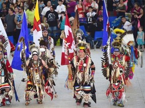 Traditional dancers start the Grand Entry during the 34th Annual Ben Calf Robe Traditional Pow Wow at the Commonwealth Rec Centre in Edmonton, May 9, 2015. The event featured a variety of dancers, drummers, crafts and food vendors.