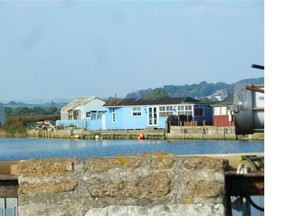 The blue house where DI Alec Hardy — played by David Tennant — resides in Season 2 of Broadchurch, located on the river in West Bay, Dorset.