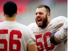 University of Laval Rouge et Or offensive linemen Danny Groulx, right, and Michel Boudreault joke around during a football practice in Vancouver, B.C., on Nov. 22, 2011.
