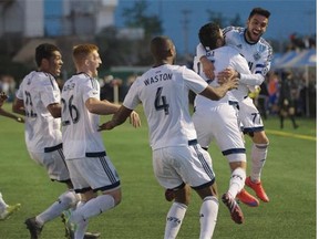 The Vancouver Whitecaps celebrate the game-winning goal by Matias Laba (15) in added time Wednesday at Clarke Field. The Whitecaps defeated FC Edmonton 2-1 during the second leg of the Amway Canadian Championship semifinal series to win the aggregate score 3-2.