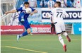 Vancouver Whitecaps’ Pedro Morales (77) battles for the ball with Edmonton FC’s Cristian Raudales (7) during second half action of the Amway Canadian Championship semifinal at Edmonton’s Clarke Stadium on May 20, 2015.