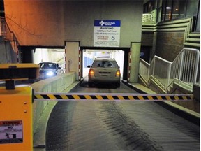 Vehicles pass at the entrance to the underground parkade at the University of Alberta Hospital in this Nov. 28, 2011 file photo. As one of its campaign pledges, the Wildrose says it will press for two free hours of parking for those visiting loved ones in hospital.