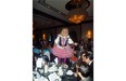 Waiter Nick Lees sings on a table he is serving at the Children’s Wish Foundation gala, held last Thursday at the Chateau Lacombe Hotel.