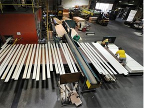 Workers cut and bundle up lumber at Spruceland Millworks west of Edmonton. Will the new NDP government mean an exodus of workers from Alberta?