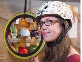 Buy your athletic mother a colourful helmet to protect her noggin. Here, Kim Snider tries on a Nutcase helmet at Redbike in Garneau.