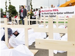 Activists are pictured during a protest called “Red Card for FIFA. No World Cup in Qatar without workers rights!” The event was organized by the Swiss trade union UNIA outside the Hallenstadion in Zurich, Switzerland during the 65th FIFA Congress on May 29, 2015.
