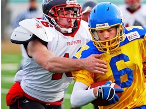 Brad Tattrie of the Fort McMurray Trappers is about to wrap up Gary Gall of the Bev Facey Falcons during a high school football playoff game on Nov. 12, 2005.