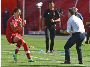 Christine Sinclair celebrates with head coach John Herdman after scoring Canada’s only goal against China on a penalty kick in extra time during the opening game of the FIFA Women’s World Cup at Commonwealth Stadium on June 6, 2015.