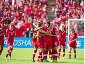 Christine Sinclair (12) and teammates celebrate Canada’s 1-0 win over China in the opening match of the Women’s World Cup in Edmonton.