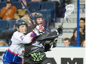 Cory Conway of the Edmonton Rush battles with Glen Bryan of the Toronto Rock during a National Lacrosse League game at Rexall Place on Feb. 27, 2015.