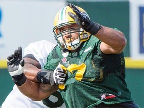 Defensive tackle Eddie Steele tries to bull his way past an offensive lineman during an Edmonton Eskimos training camp at Fuhr Sports Park in Spruce Grove on June 10, 2015