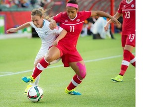 Desiree Scott (11) of Canada jockeys with Annalie Longo (16) of New Zealand at Commonwealth Stadium in the round robin of the FIFA Women’s World Cup in Edmonton.