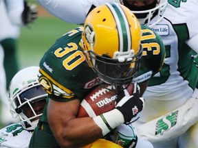 Edmonton Eskimos running back John White carries the ball during the 2014 West Division semifinal against the Saskatchewan Roughriders at Commonwealth Stadium on Nov 16, 2014.