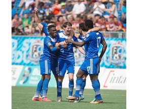 FC Edmonton players surround striker Daryl Fordyce, centre, after defeating the Atlanta Silverbacks in Sunday’s North American Soccer League game at Clarke Field.